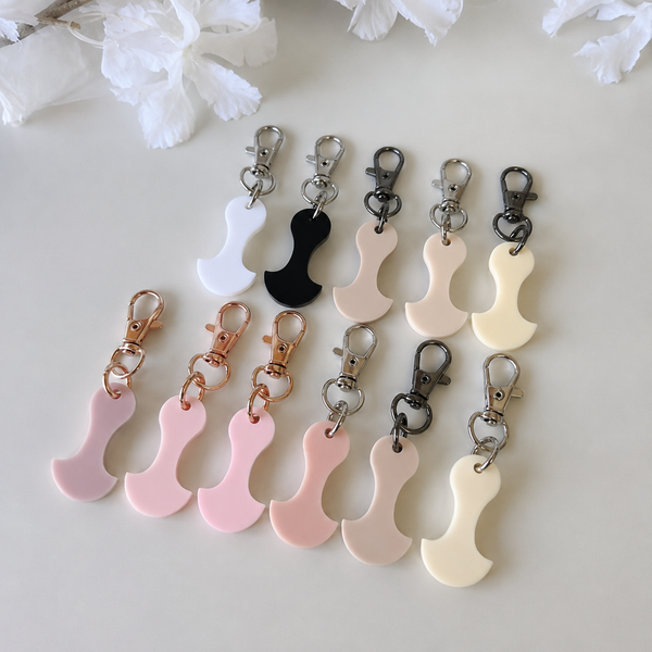 Acrylic trolley tokens with lobster clasps, the size of a two dollar coin