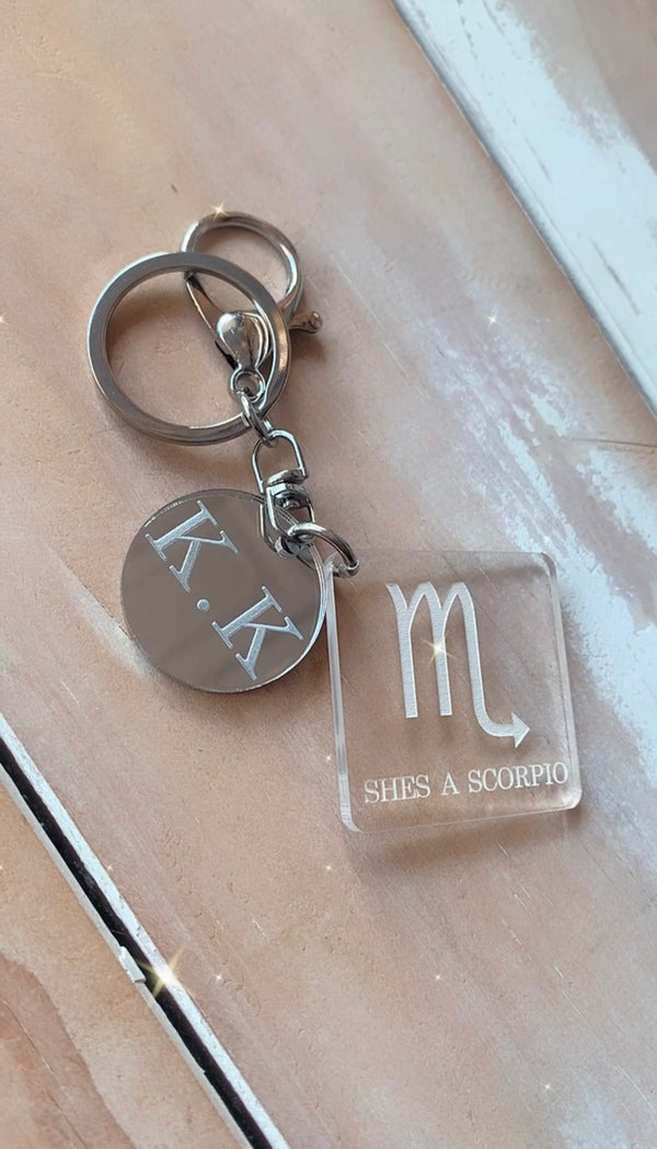 Zodiac keyring with a star sign engraved on clear acrylic and a mirrored initial charm