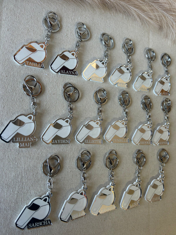 Personalised umpire whistle keyring in double layered mirrored acrylic, engraved with the umpire's name