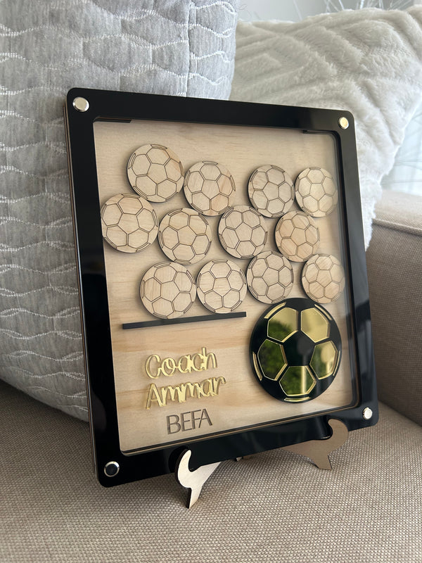 Personalised sporting coach drop box in layered wood and acrylic with twelve wooden ball pieces for the team to sign