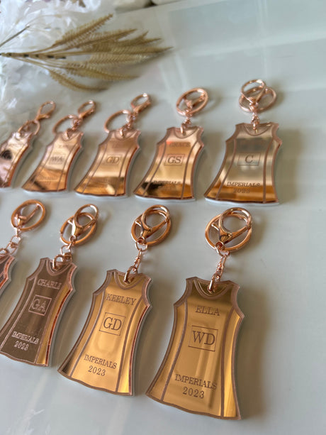 Personalised netball dress keyring with player name and position in team colours, laser-cut mirrored acrylic