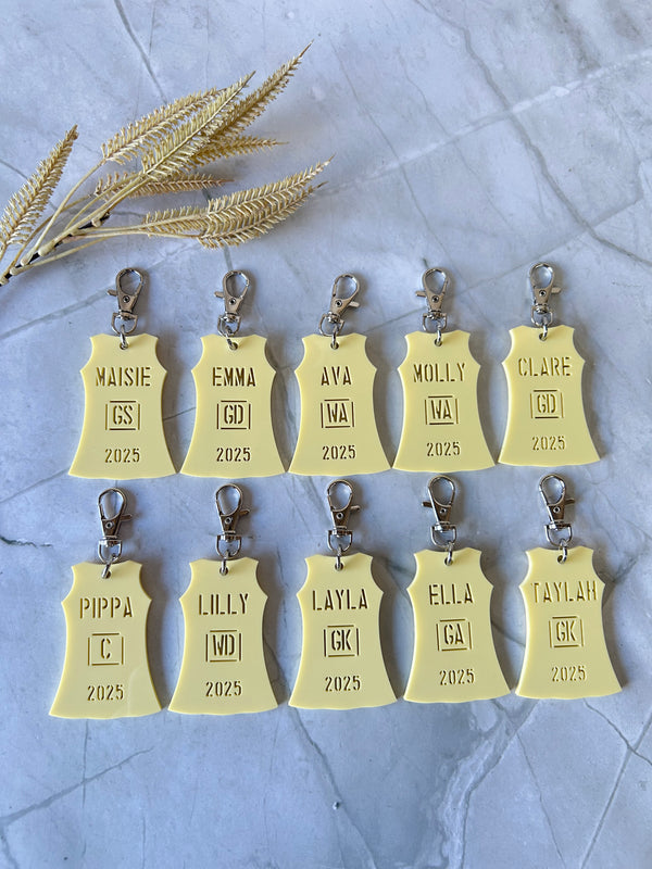 Personalised netball dress bag tag with player name and position in team colours, engraved acrylic