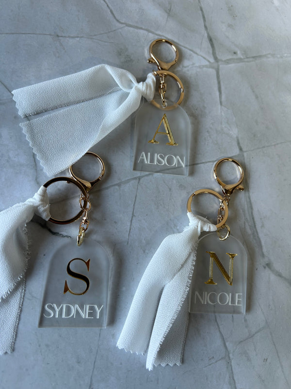 Engraved luxe initial keyring in frost and mirror acrylic with a ribbon