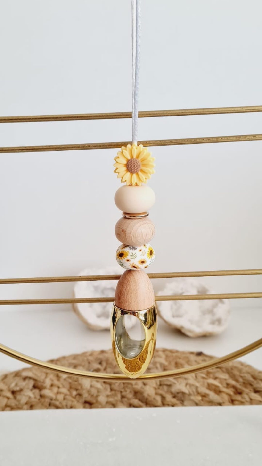 Sunny personalised acrylic car diffuser hanging from a rear view mirror