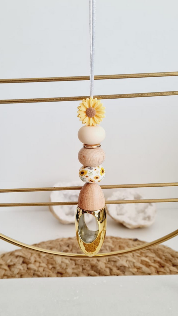 Sunny personalised acrylic car diffuser hanging from a rear view mirror