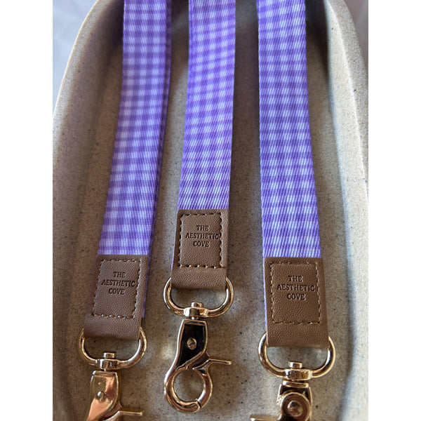Purple gingham fabric lanyard with an optional engraved clear acrylic charm
