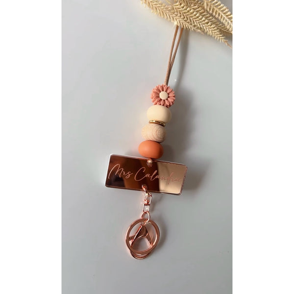 Daisy silicone beaded lanyard with a personalised engraved mirrored acrylic piece