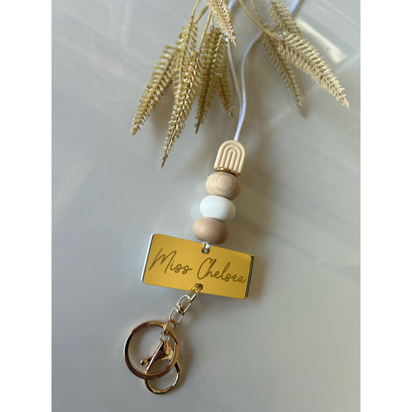 Cream silicone beaded lanyard with a personalised engraved mirrored acrylic piece