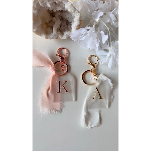 Luxe initial keyring in frost and mirror acrylic finished with a ribbon