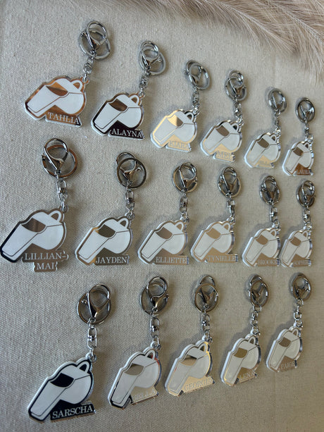 Personalised umpire whistle keyring in double layered mirrored acrylic, engraved with the umpire's name