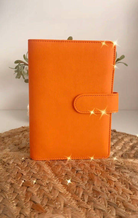 Orange A6 budget binder with five cash envelopes for cash stuffing
