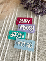 Personalised acrylic bag tags laser cut in Sydney in your choice of colour and name