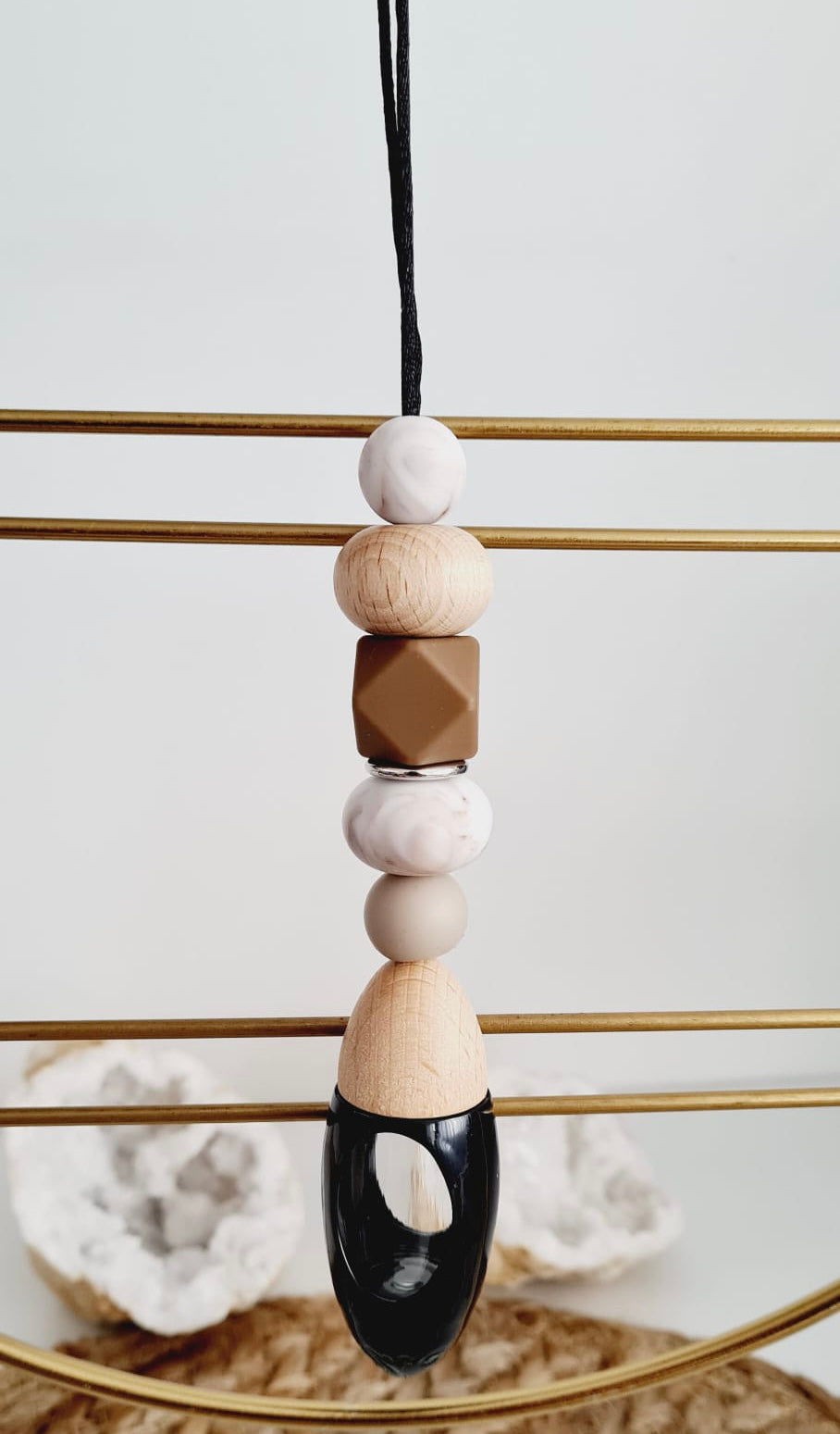 Toffee personalised acrylic car diffuser hanging from a rear view mirror